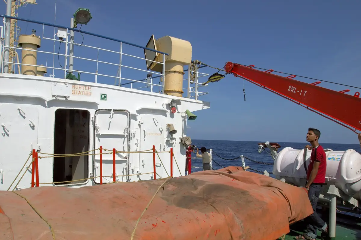 White passenger ship with a deck crane at sea in the Andaman Islands