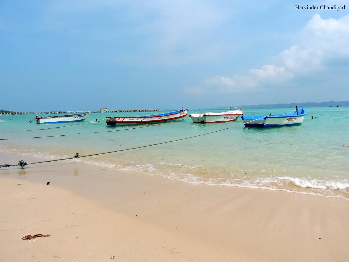 Boats on the sand at Bharatpur Beach with turquoise water on Neil Island