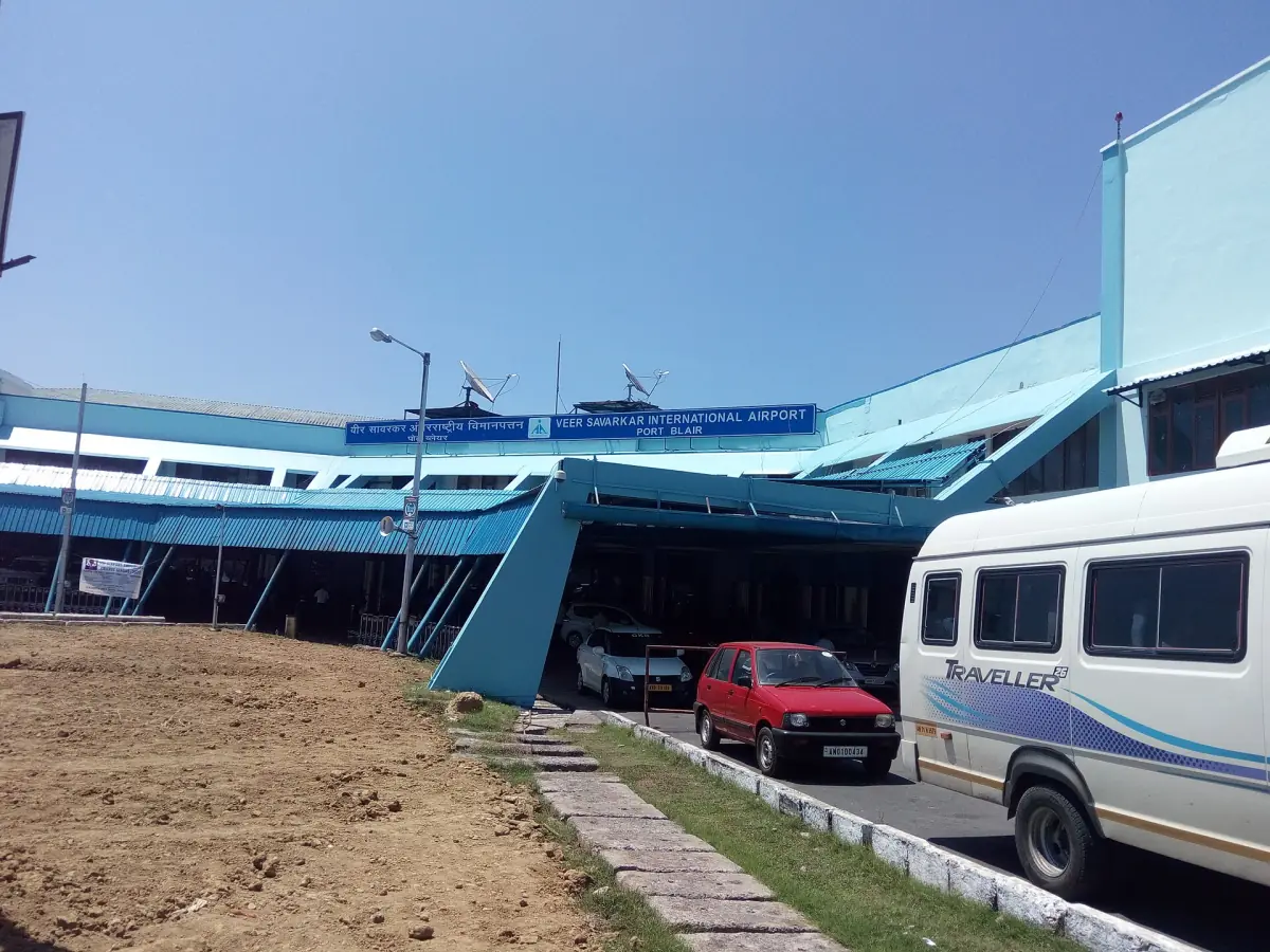 Terminal building of Port Blair airport with a shuttle van outside